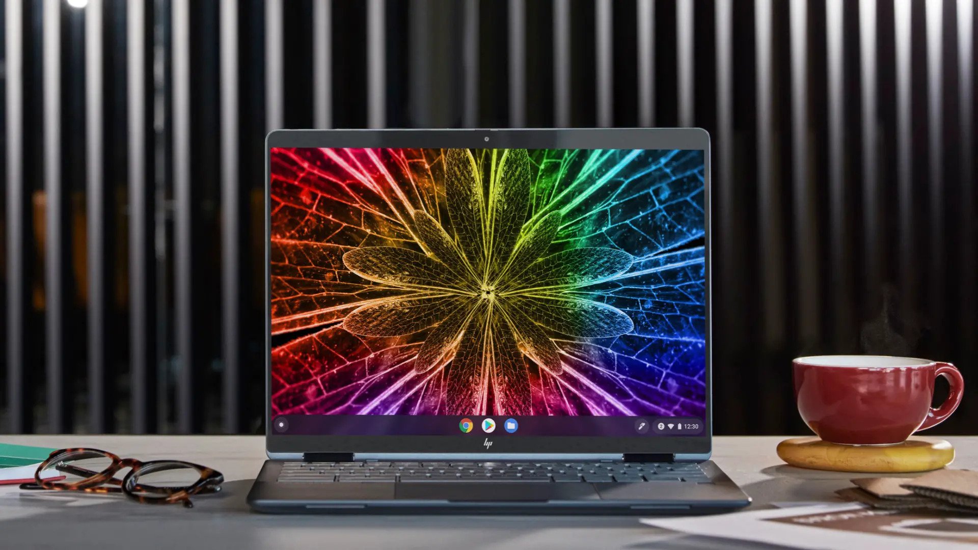 best chromebooks - an image of the hp dragonfly elite on a desk alongside glasses and a coffee mug