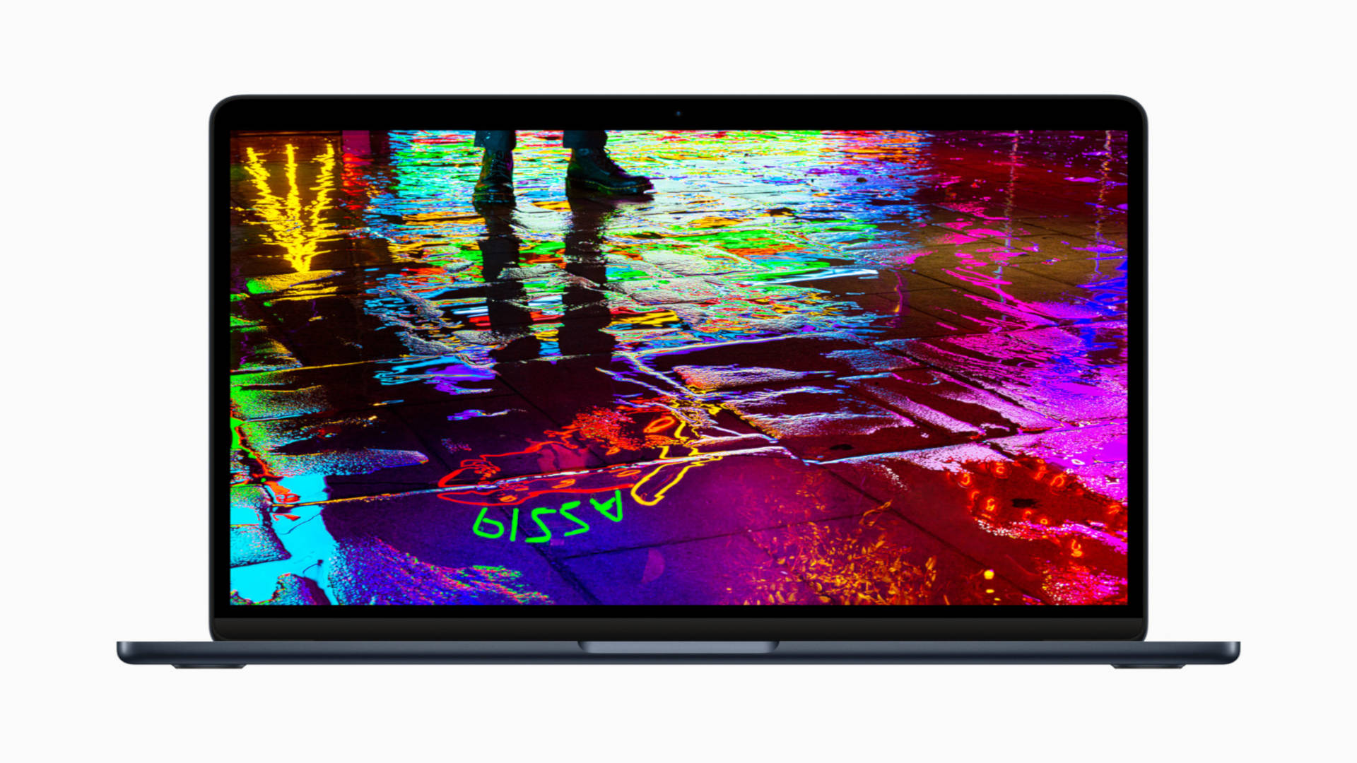 best laptops - an image of the apple macbook air with a neon sign reflected off water on the ground