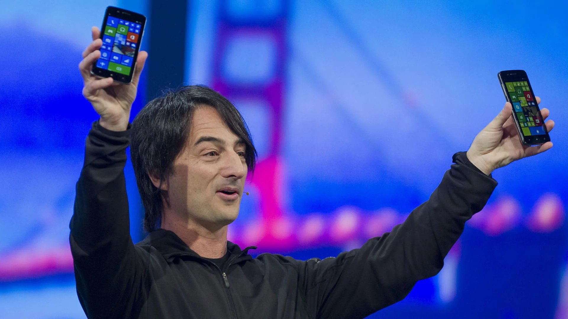 the presentation for the launch on the windows phone with a man holding up two smartphones